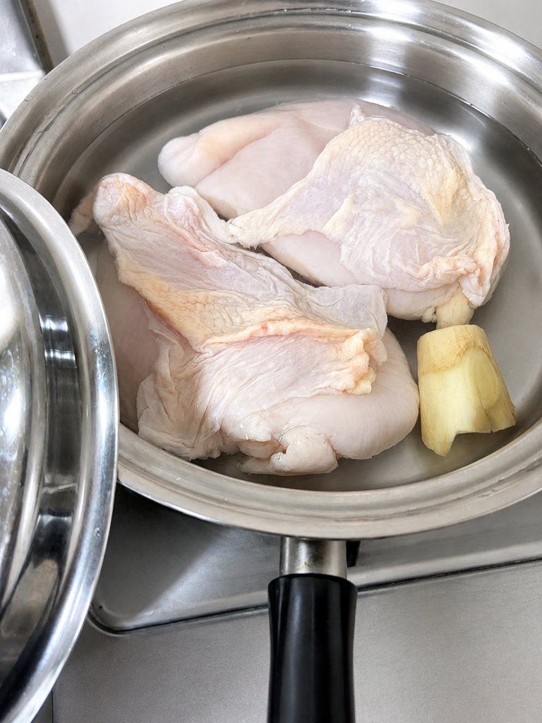 コストコ鶏むね肉を生姜と一緒に鍋で茹でる準備

